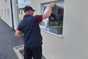 Andrew watering a plant
